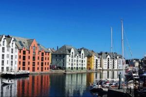 a group of buildings and boats in a harbor at Family friendly, Free Parking, in Best Part of the City in Ålesund