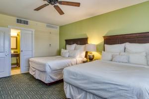a hotel room with two beds and a ceiling fan at New Hotel Collection Harbourside in Clearwater Beach