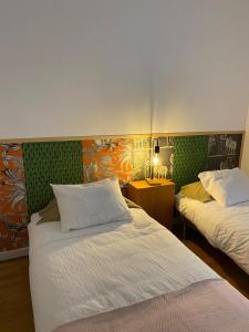 a hotel room with two beds and a desk at GALLE - Apartamento dos Infantes in Beja