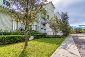 un edificio de apartamentos con un árbol en el patio en New Hotel Collection Harbourside en Clearwater Beach