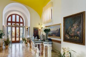 a living room with a painting on the wall at Antico Casale Russo in Piano di Sorrento