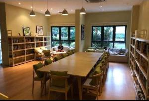 a large room with a large wooden table and chairs at COUNTRY GARDEN@J Agape Homestay STUDIO 3C in Johor Bahru