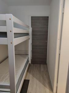 a small room with bunk beds and a closet at CHALET CLUB VAL CLARET 1 46 in Tignes