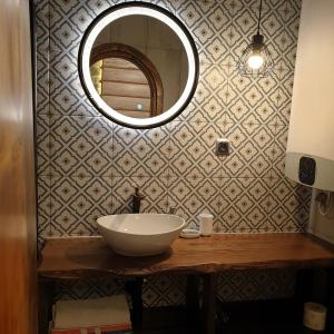 a bathroom with a sink and a mirror at Apartament Zborowskiego in Zakopane