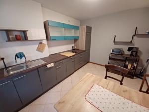 a large kitchen with a sink and a table at Casa Giulia in Grado