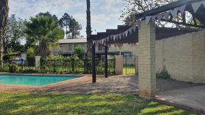a backyard with a swimming pool and a fence at KatiKati Eco Lodge in White River