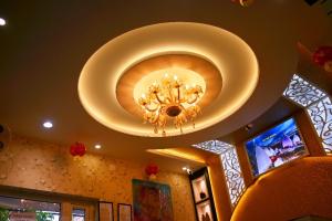 a chandelier hanging from a ceiling in a building at Hotel Bharati in Deoghar