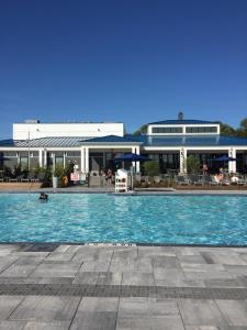 a large swimming pool in front of a building at Stunning Stayz Luxury 2 King Suite at Friday Harbour Resort Marina Walk & Parking in Innisfil