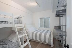 a bedroom with two bunk beds and a ladder at Expansive Ocean View, Private Balcony, Across from Beach in Carlsbad
