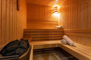 a sauna with a tub and towels in it at Abrazo Sofia Hotel by HMG in Sofia