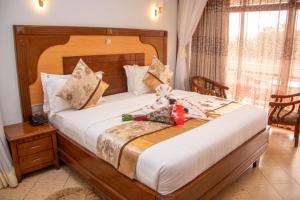 Postel nebo postele na pokoji v ubytování Grand Winston Hotel