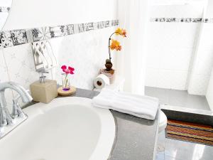 a white bathroom with a sink and a toilet at STYLISH & Spacious Apartment in Cusco