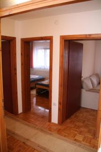 a room with three doors and a room with a bedroom at Apartman Vuvuzela in Kupres