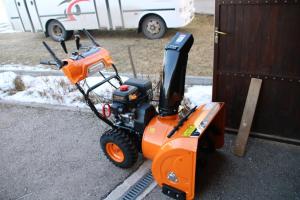 an orange mobility scooter parked next to a building at Apartman Vuvuzela in Kupres