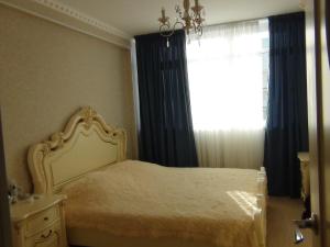 a bedroom with a bed and a window with curtains at Apartment in Gagra in Gagra