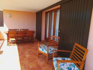 a dining room with wooden chairs and a table at Sealine Villa with an amazing view of Tavolara in Olbia