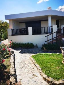 a house with a stone walkway in front of a house at Sealine Villa with an amazing view of Tavolara in Olbia