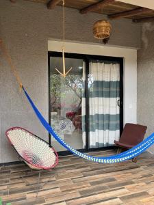 a hammock in front of a house at Casa Biznaga in Oaxaca City