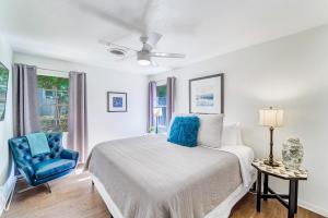 a bedroom with a bed and a blue chair at The Mariposa Wing B by Lodgewell - Spread your wings here in Austin