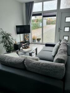 a living room with a couch and a large window at Fewo Ostseenähe in Bentwisch