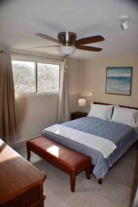 a bedroom with a bed and a ceiling fan at Blue Sky 1 bedroom apartment in Simpson Bay in Koolbaai