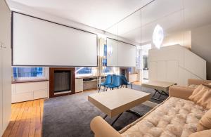 a living room with a couch and a table at Élégant studio avec mezzanine porte des Ternes in Paris