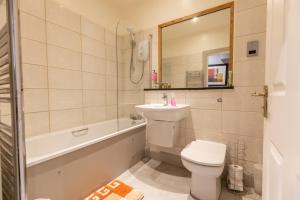 a bathroom with a sink and a toilet and a bath tub at Two Bedroom Apartment Within Walking Distance to City Centre in Edinburgh