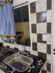 a bathroom with a sink and a mirror at Brisas del Mar ll in San Clemente del Tuyú