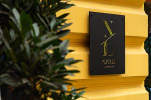 a clock on a yellow wall next to a plant at CenterMini Rooms with Parking - Best Location & Value in Belgrade +30 photos