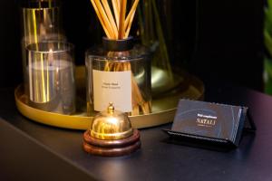 a table with a bottle and a book and candles at CenterMini Rooms with Parking - Best Location & Value in Belgrade