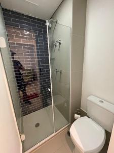 a bathroom with a toilet and a glass shower at Unique (Ex-Estanconfor) veja o mar do apto 1706 in Santos +12 photos