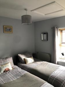 una camera con due letti accanto a una finestra di Dove cottage ad Allonby