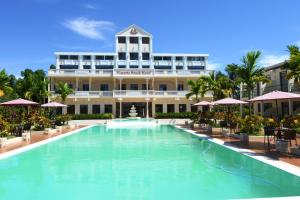 a large swimming pool in front of a building at Victoria Beach Hotel in Toamasina