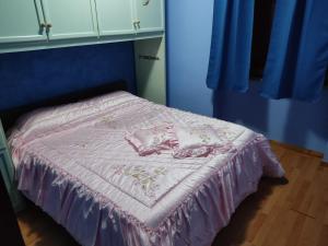 a bed with a pink bedspread and pillows on it at Affittacamera Mauro vasto in Vasto