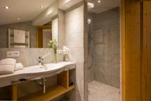 a bathroom with a sink and a shower at Landhotel Lechner Appartements in Kirchberg in Tirol