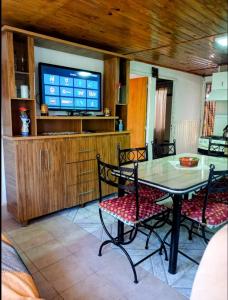 una sala da pranzo con tavolo, sedie e TV di Hermosa casa de vacaciones en Mendoza a Guaymallén