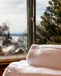 a towel sitting on a table in front of a window at Tierra Gaucha Hostel Boutique in San Carlos de Bariloche