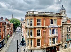 an old building on a city street with the capitolivating at Luxurious City Centre Lace Market Apartment in Nottingham