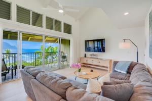 a living room with a couch and a table at Pali Ke Kua #215 in Princeville