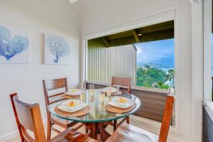 a dining room with a table and chairs and a window at Pali Ke Kua #215 in Princeville