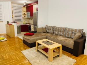 a living room with a couch and a coffee table at Jolly Apartment - Belgrade in Belgrade