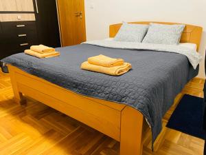 a bedroom with a bed with two towels on it at Jolly Apartment - Belgrade in Belgrade