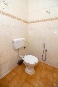 a bathroom with a toilet and a shower at GRG Traveller in Panaji