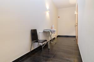 a room with a chair and a desk and a door at Jundula in Šakiai