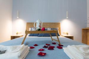 a bed with red rose petals on the floor at Casa di Prios brand new renovated Villa in Gouves in Gouves