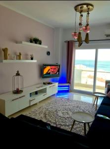 a living room with a couch and a tv at Bright Get Away Condo in Sharm El Sheikh