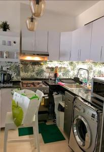 a kitchen with a washing machine and a dishwasher at Bright Get Away Condo in Sharm El Sheikh