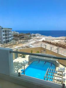 a view of a balcony with a swimming pool at Bright Get Away Condo in Sharm El Sheikh