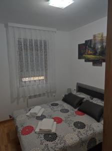 a bedroom with a bed with a table and chairs at Apartman IKS-M & Spa in Zlatibor