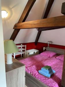 a bedroom with a bunk bed with books on it at Maison en pierre sur les Quais de la Dordogne in Argentat